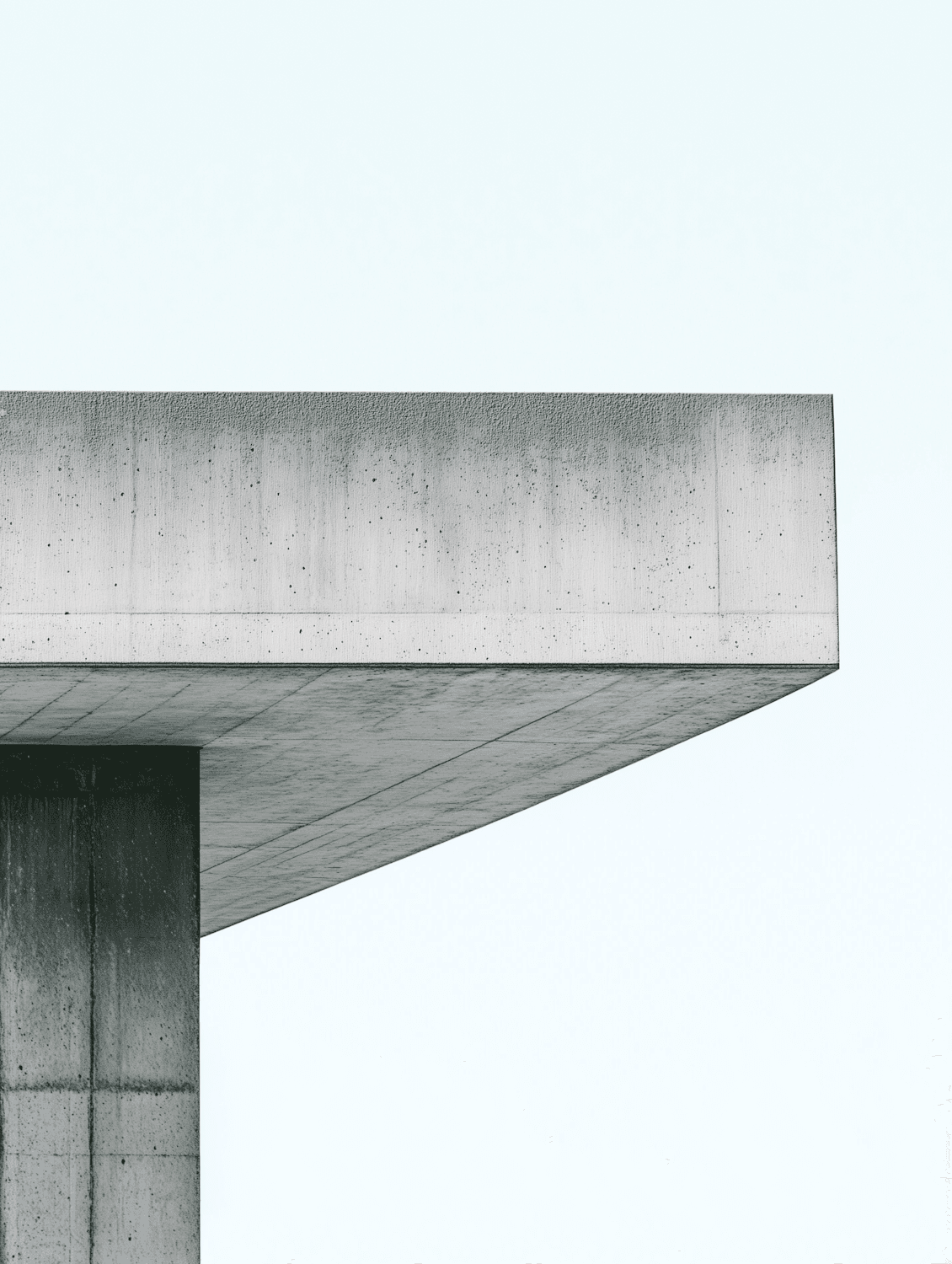 Concrete roof of Lysning Pavilion cantilevering from its single core against a pale sky