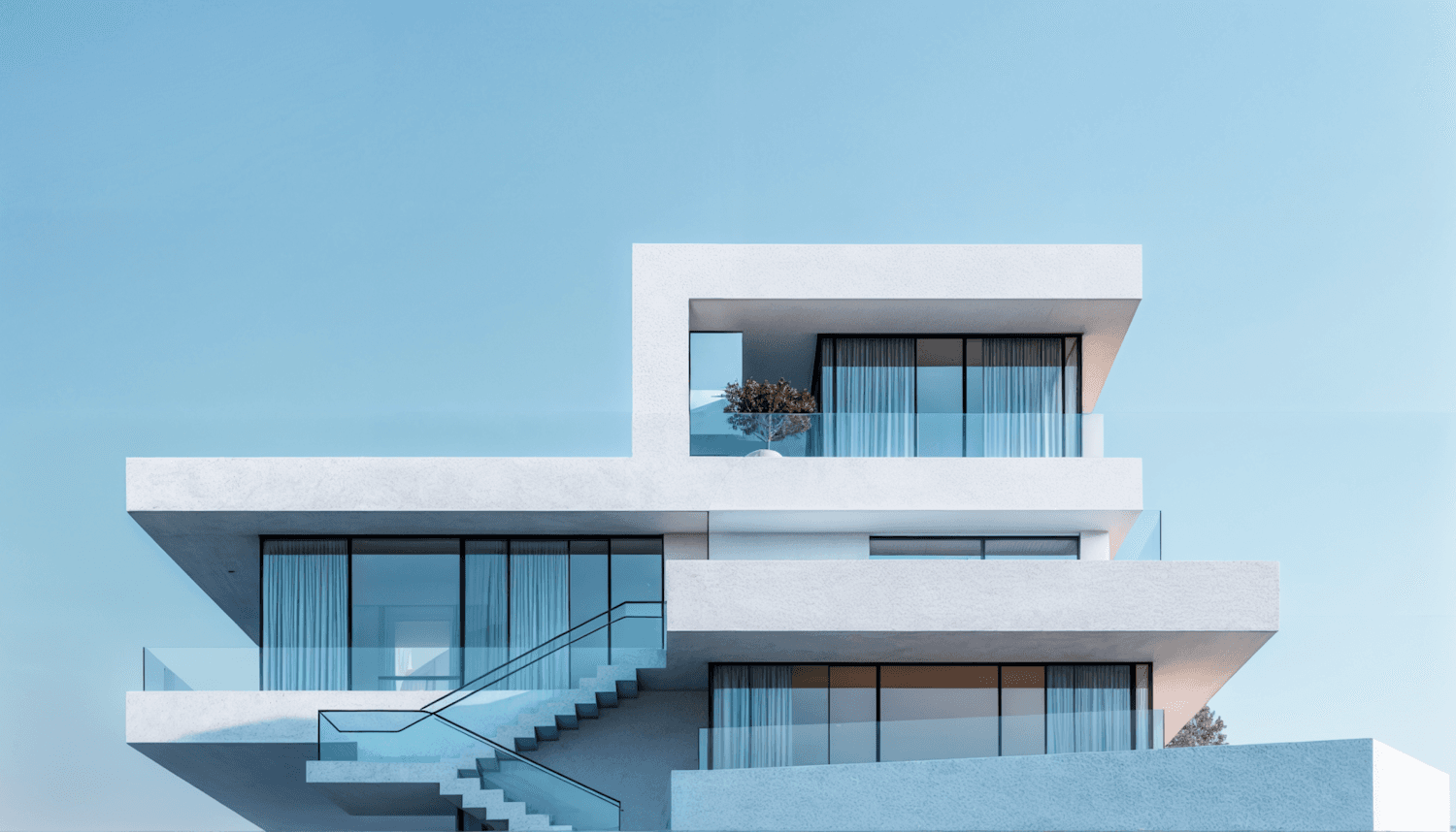 White terraces of Villa Klint stepping out above each other, with an outdoor stair and glass balustrades